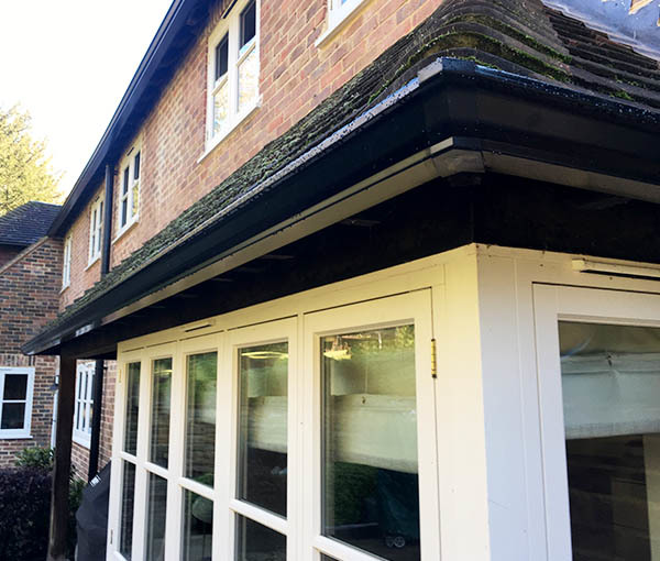 A close-up of black ogee aluminium guttering that has been recently installed.