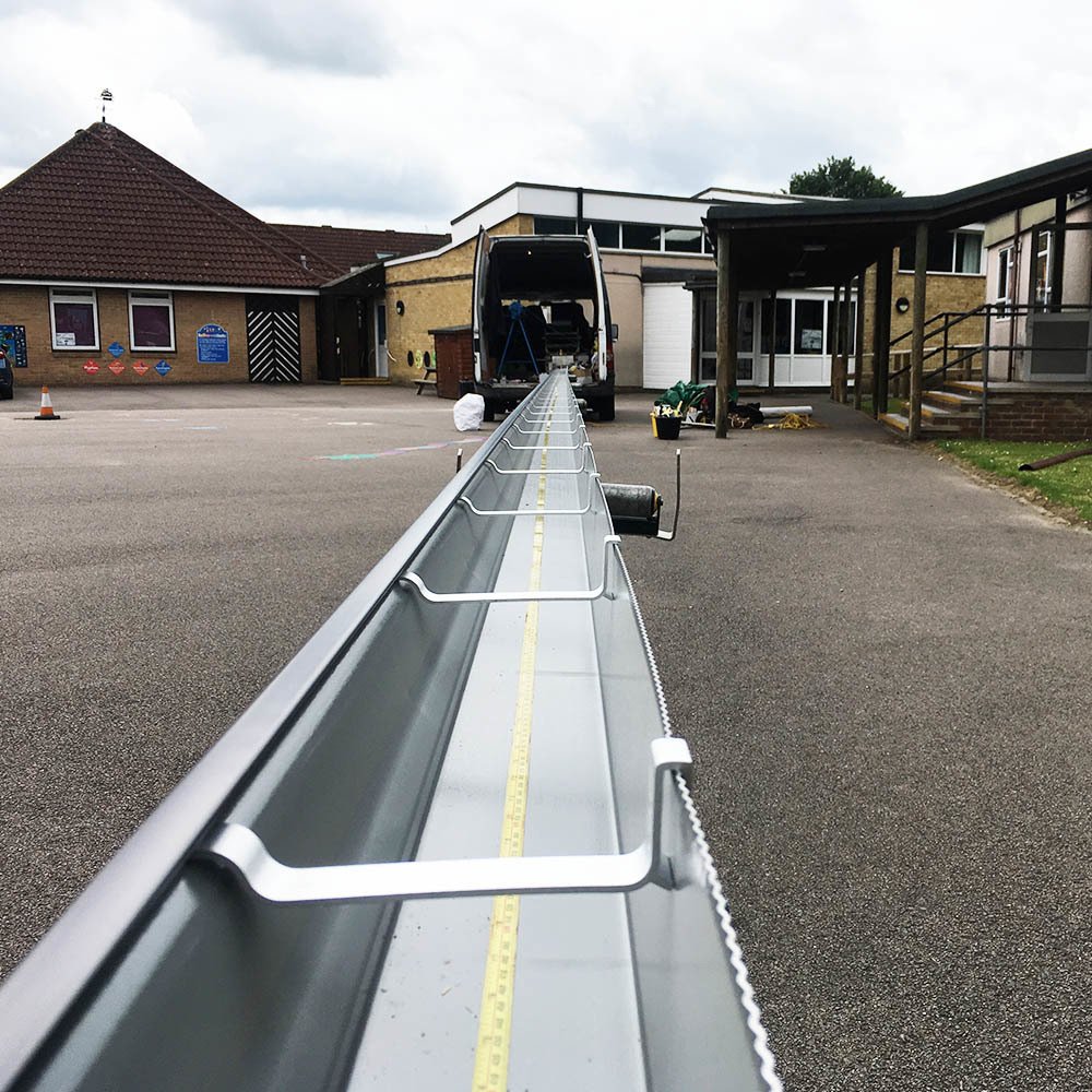 Aluminium commercial guttering being installed on a commercial property.